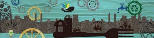 A long outdoor wall artwork depicting a cityscape silhouette with gears and environmental symbols.