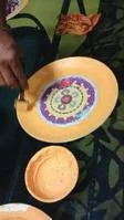 A hand decorating a plate